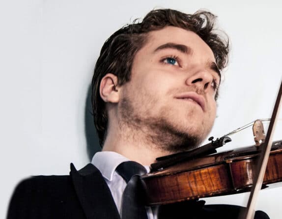 Emmanuel Coppey playing the violin at a performance