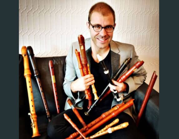 Vincent Lauzer seated with a collection of recorder instruments