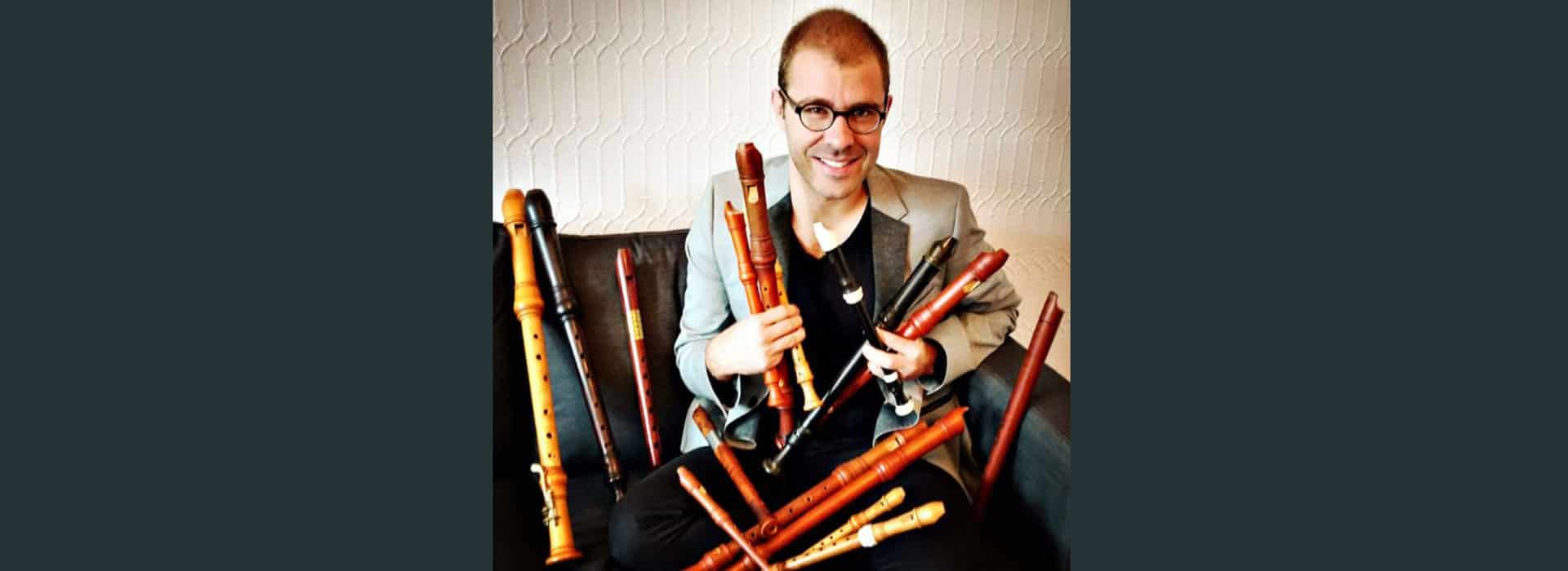 Vincent Lauzer seated with a collection of recorder instruments