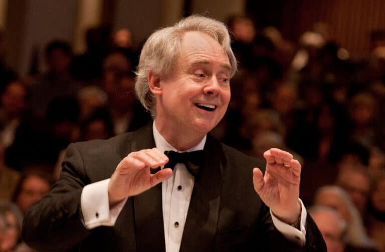 J. Reilly Lewis smiling as he directs the Washington Bach Consort