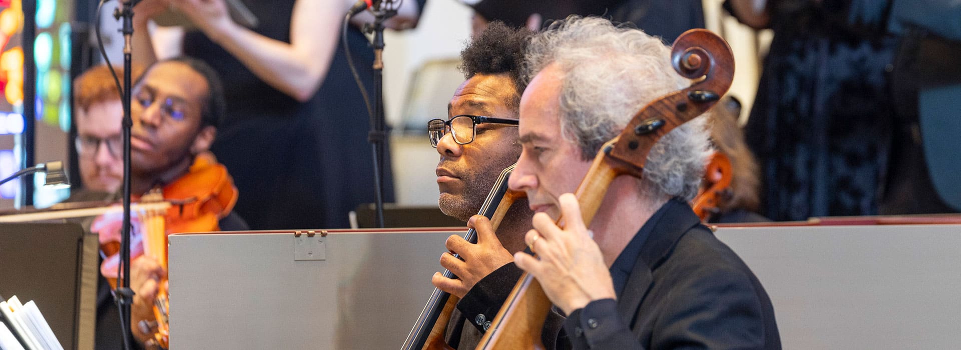 Two cellists facing right